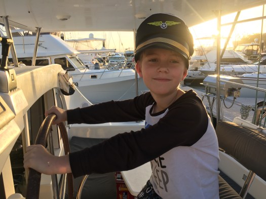 Young boy sailing the catamaran